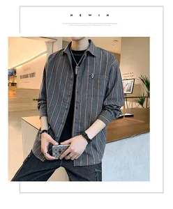 Loose-fitting grey long-sleeved shirt with orange vertical stripes in a lifestyle setting