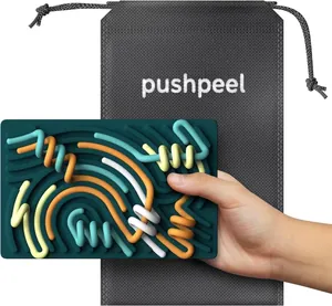 Close-up of sensory activity board with colorful silicone strips and storage bag.