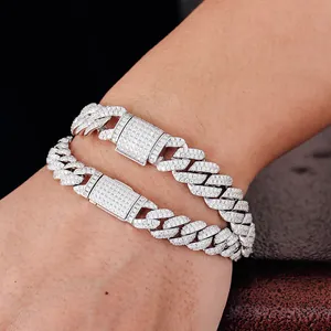 Detailed close-up of two iced-out moissanite Cuban link bracelets worn on a wrist