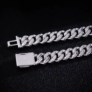 Macro view of S925 sterling silver Cuban link bracelet with polished clasp detail