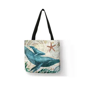 Detailed view of linen tote bag with artistic blue whale and starfish ocean print