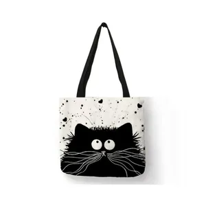 Linen tote bag featuring a cute black cat cartoon print with splattered heart detail.
