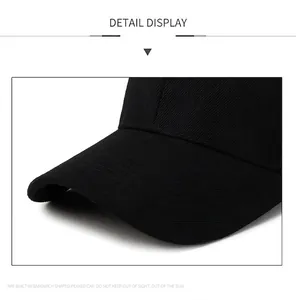 Close-up of black baseball cap brim showing high-quality fabric texture and structured peak