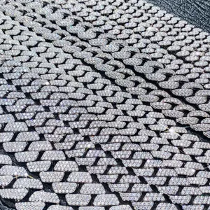 Macro detail of iced out Cuban link bracelet with pavé set moissanite stones in 925 silver.