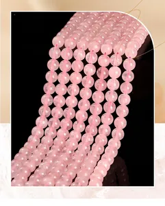 Macro shot of natural rose quartz round beads with smooth pink finish