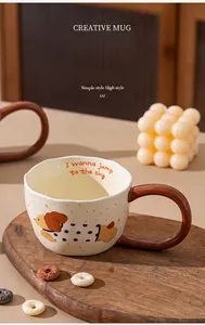 Close-up of a creative ceramic mug with cartoon dog pattern and brown handle