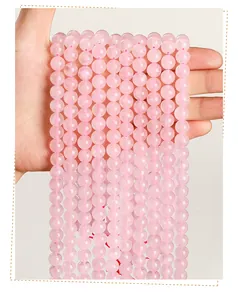 Macro detail of natural pink rose quartz round beads for handmade DIY jewelry crafting