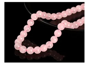 Close-up macro view of natural pink rose quartz crystal beads for DIY jewelry making