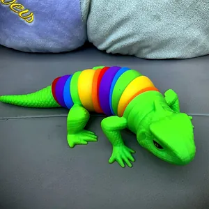 Close-up of a colorful 3D printed articulated lizard fidget toy on a soft surface.