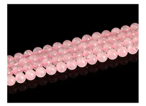 Macro detail of translucent natural rose quartz crystal round beads for DIY jewelry making