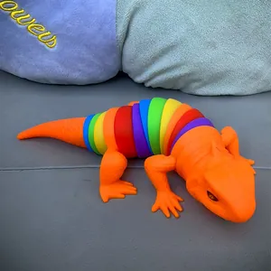 Close-up view of a colorful rainbow segmented fidget lizard toy with an orange head.