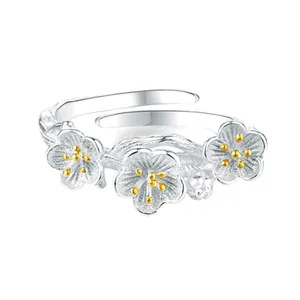 Elegant silver-toned open ring featuring three detailed golden-centered plum blossoms