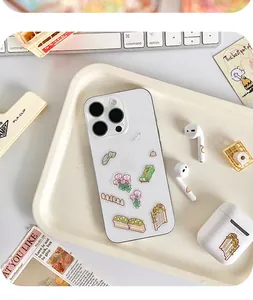 Close-up of 3D miniature garden stickers applied to a white smartphone case.