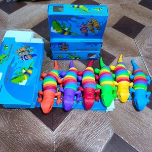 Detailed view of colorful segmented lizard toys with blue gift packaging boxes.