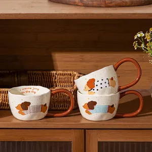 Set of creative cartoon dog ceramic mugs with large handles on a stylish wooden shelf