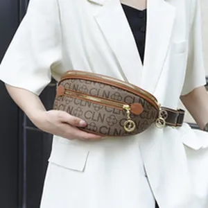 Detailed view of fashionable ethnic style women's crossbody bag with monogram pattern on model