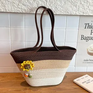 Detailed view of handmade woven tote bag with sunflower decor and gradient brown colors