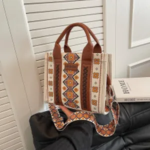 Ethnic pattern canvas tote bag with wide strap detail and leather handles