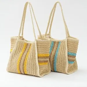 Two ethnic woven straw shoulder bags with yellow and blue stripes on white background.