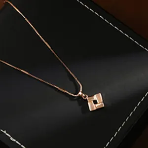 Close-up of elegant rose gold geometric square pendant on a fine necklace chain