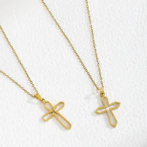 Detailed view of two gold-plated cross pendants featuring unique geometric designs on a chain.