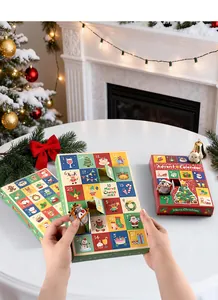 Close-up of hands opening a 24-grid Christmas advent calendar box with plush toys.