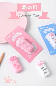 Close-up of cute cat paw shaped correction tapes in pink and white retail packaging