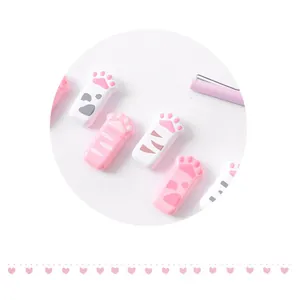 Macro view of cute cat paw shaped correction tapes in pink and white patterns
