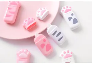 Detailed close-up of cute cat paw shaped correction tapes in soft pink and white colors.