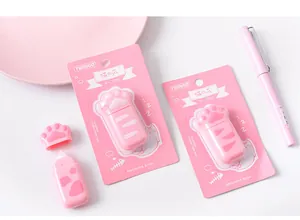 Adorable pink cat paw shaped correction tape shown in original packaging and opened.