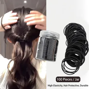 Detail view showing 100pcs black high elasticity hair ties in a jar and ponytail styling.