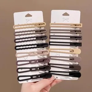 Set of 16 minimalist geometric hair clips in neutral earthy matte tones on cards