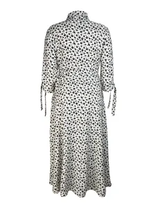 Back view of a black and white floral print long sleeve midi dress with tie cuffs.