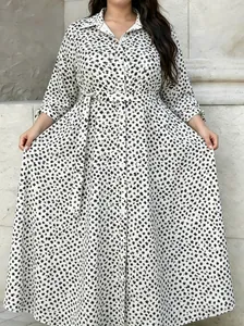 Plus size long-sleeved shirt dress with black floral print on a white background