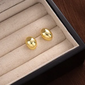 Elegant gold-tone polished dome stud earrings presented in a premium jewelry box