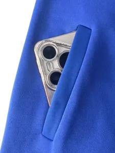 Detail of royal blue fleece-lined sports jacket pocket with a smartphone showing storage