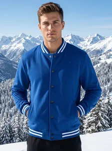 Blue American-style baseball jacket with white striped ribbing shown in a snowy mountain setting