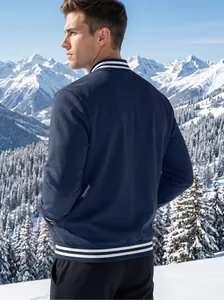 Rear view of a navy blue men's fleece baseball jacket in a snowy mountain setting
