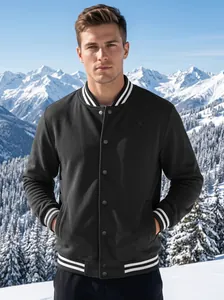 Classic black varsity jacket with white stripe details shown in a snowy mountain scene