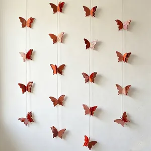 Elegant 3D reddish-orange butterfly paper garlands for festive wall decoration.