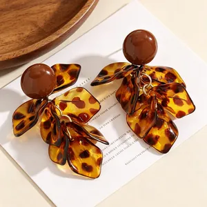 Macro detail of high-quality leopard print petal fringe earrings in brown Maillard tones