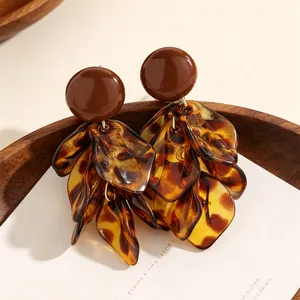 Detail view of stylish leopard print petal tassel earrings in warm Maillard brown