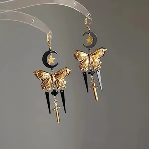 Vintage metal butterfly earrings in gold and black with crescent moon and sword charms