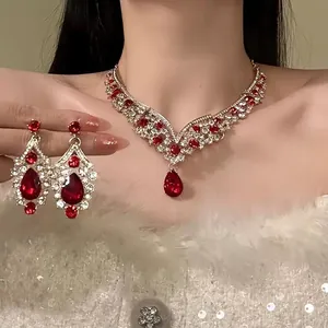 Vintage royal style jewelry set with red waterdrop rhinestones on elegant Asian model.