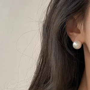 Elegant S925 silver needle large pearl stud earrings for women shown worn on the ear