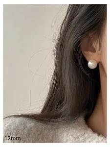 Close-up showing the 12mm iridescent pearl stud earring on an ear, elegant silver needle