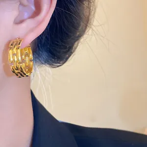 Close-up view of elegant gold-plated chain-link hoop earring for a sophisticated fashion look