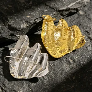 Detailed view of artistic irregular pleated knuckle rings in gold and silver finish