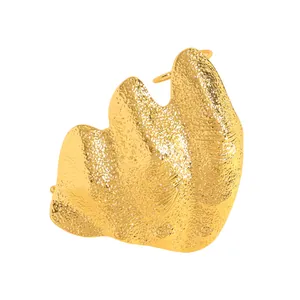 Close-up of artistic irregular folded golden ring with hammered texture detail