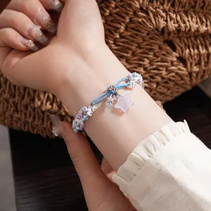 Exquisite detail of resin floral bracelet with star and moon charms worn on wrist